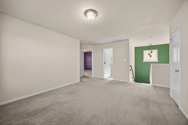an empty room with windows and closet