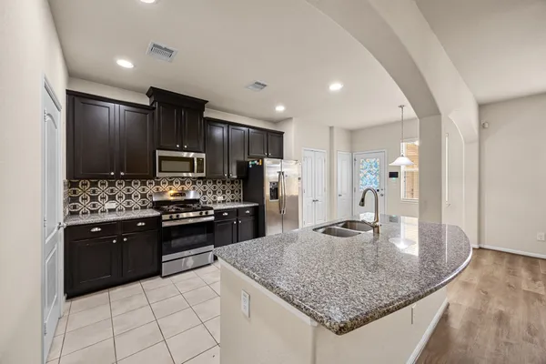 an empty room with windows and ceiling fan
