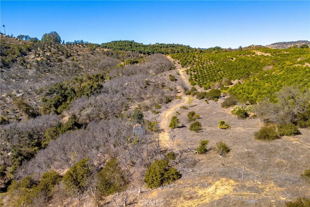 34 Los Gatos Road Temecula, CA 92590 - Photo 5 of 11 a view of a dry yard with mountains in the background