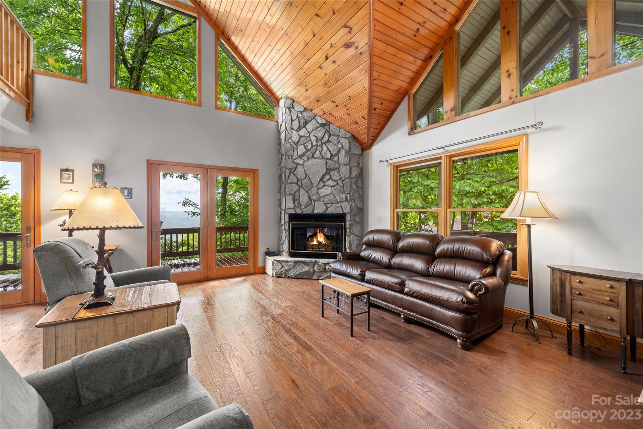 200 Kings Ridge Maggie Valley, NC 28751 - Photo 8 of 47 a living room with furniture a fireplace a lamp and a large window