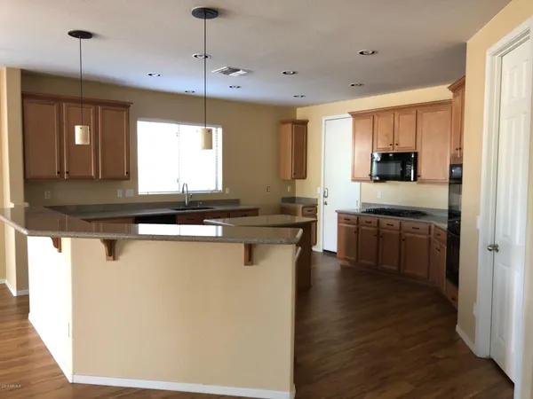 a kitchen with a sink a counter top space and stainless steel appliances