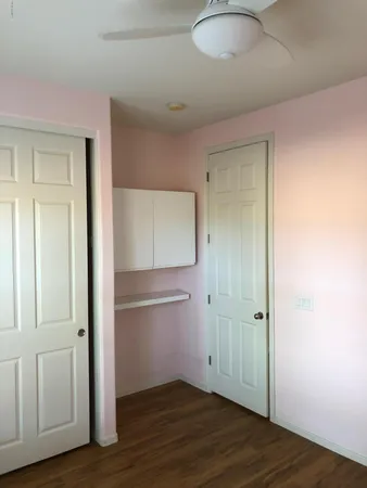 an empty room with wooden floor and closet