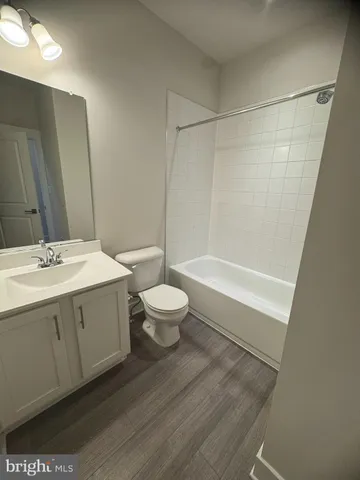 a bathroom with a double vanity sink toilet and shower