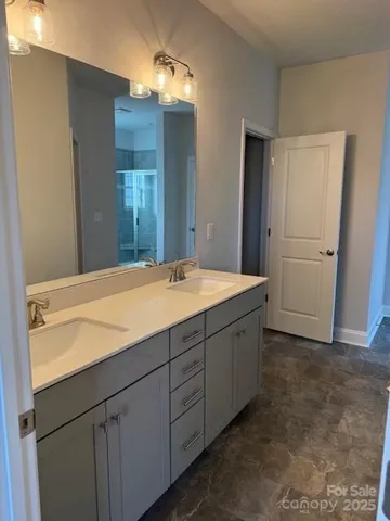 a bathroom with a double vanity sink and mirror