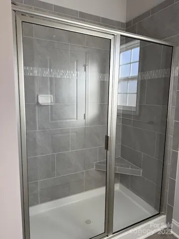 a bathroom with a glass shower door