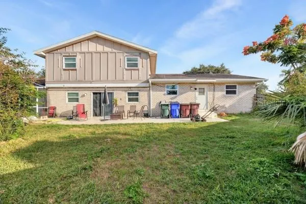 a front view of a house with a yard table and chairs