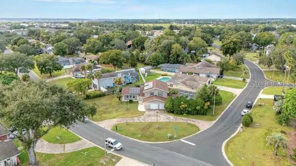 an aerial view of a house with swimming pool and mountain view