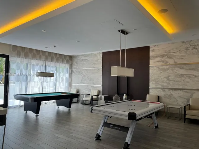 a view of barbeque area with buildings in the background