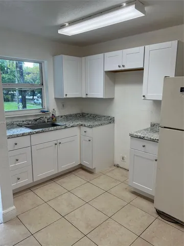 a kitchen with a stove a sink and a refrigerator