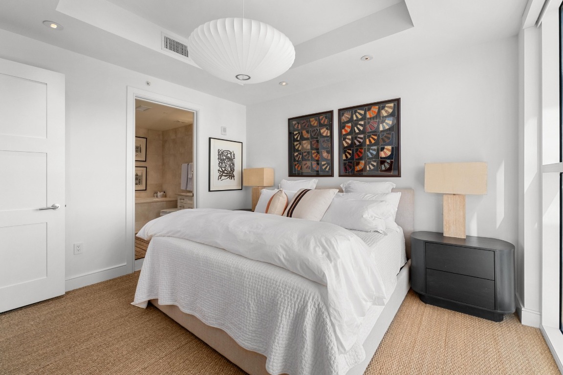 98 San Jacinto Boulevard, Unit 1201 Austin, TX 78701 - Photo 11 of 22 a bed room with a bed and a night stand