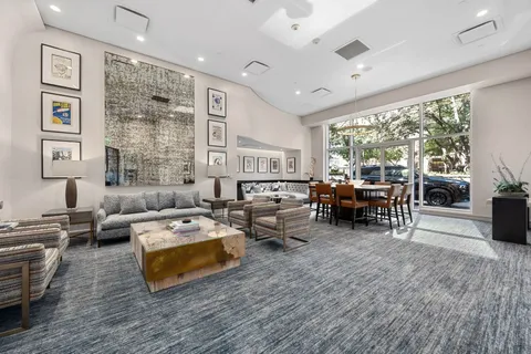 a balcony with furniture and a floor to ceiling window