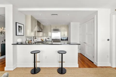 a kitchen with appliances a sink and cabinets
