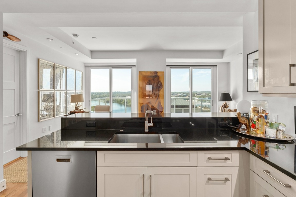 98 San Jacinto Boulevard, Unit 1201 Austin, TX 78701 - Photo 6 of 22 a kitchen with appliances a sink and cabinets
