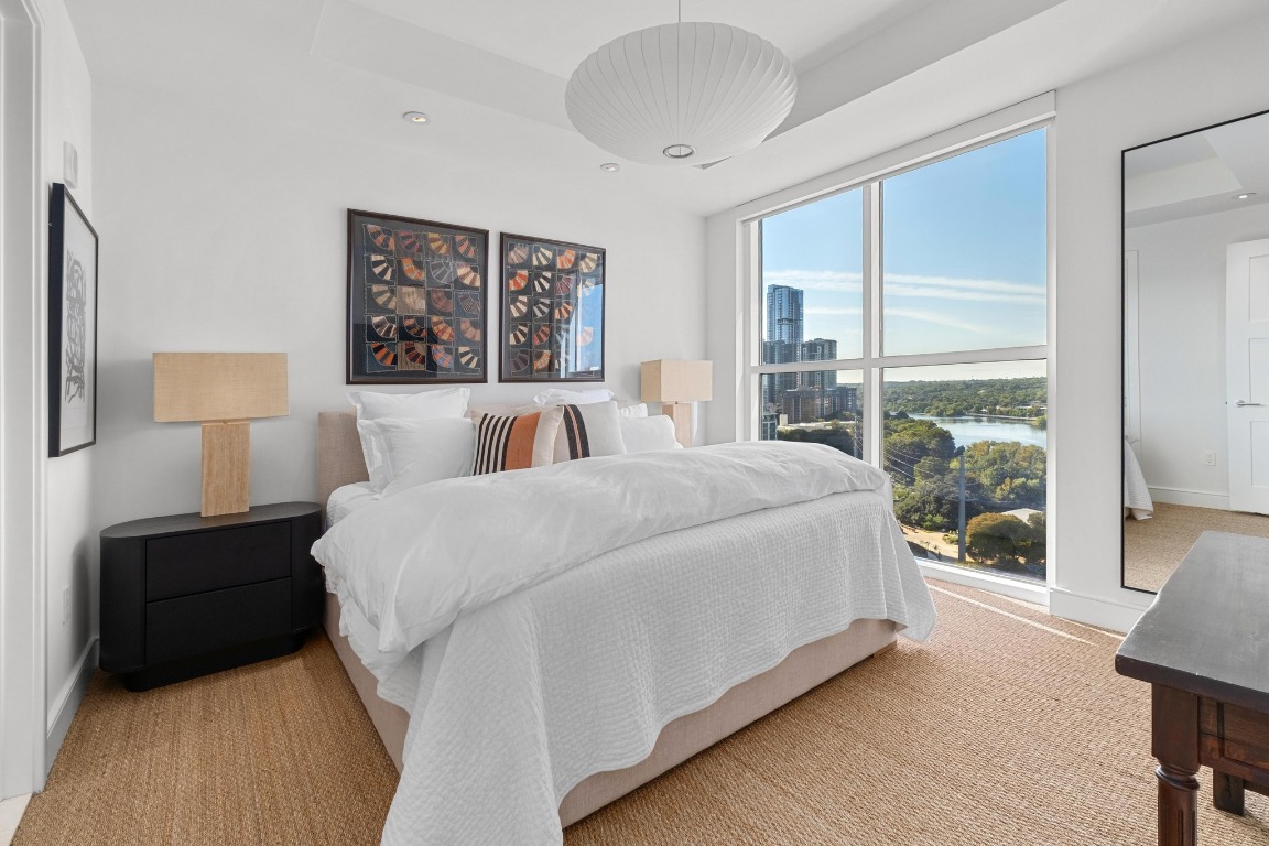 98 San Jacinto Boulevard, Unit 1201 Austin, TX 78701 - Photo 9 of 22 a bedroom with a large bed and a large window
