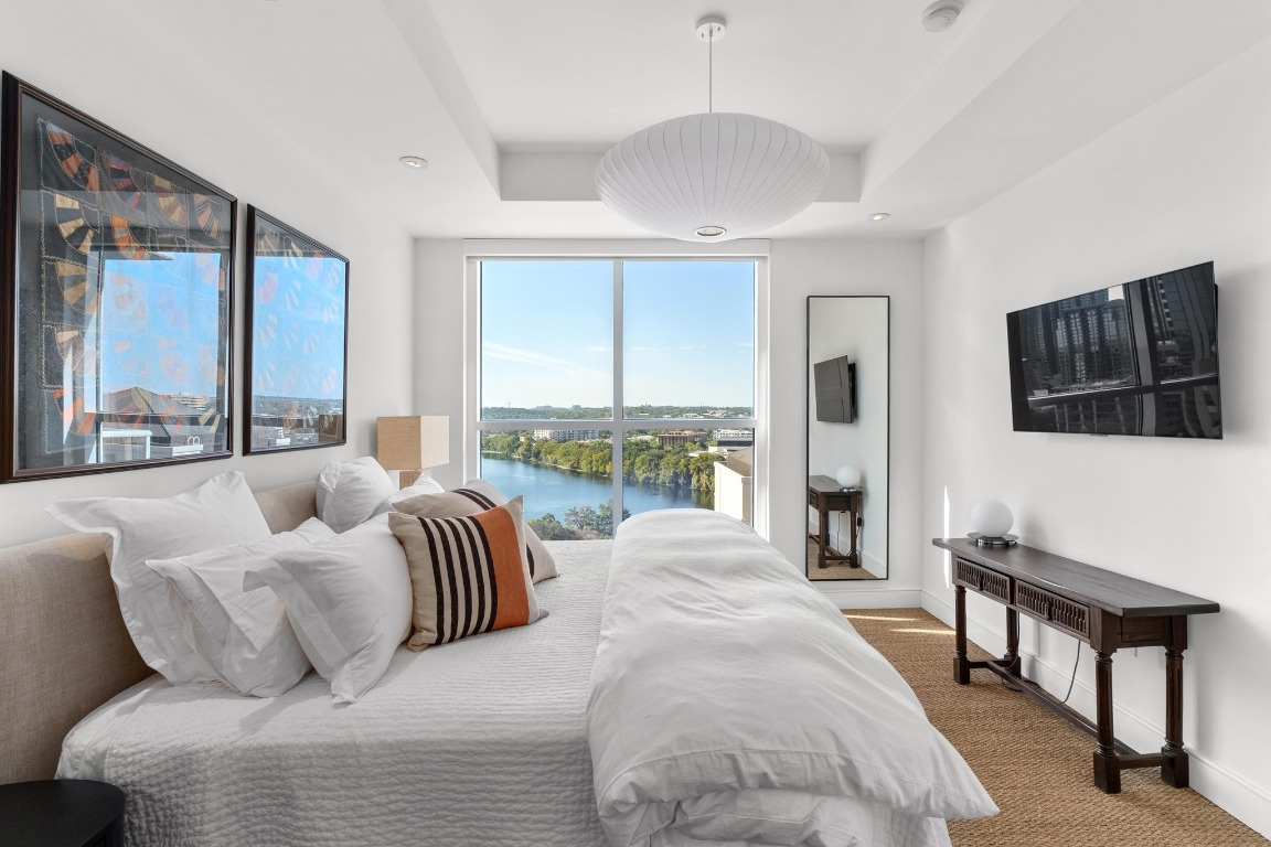 98 San Jacinto Boulevard, Unit 1201 Austin, TX 78701 - Photo 10 of 22 a living room with furniture fireplace and a large window