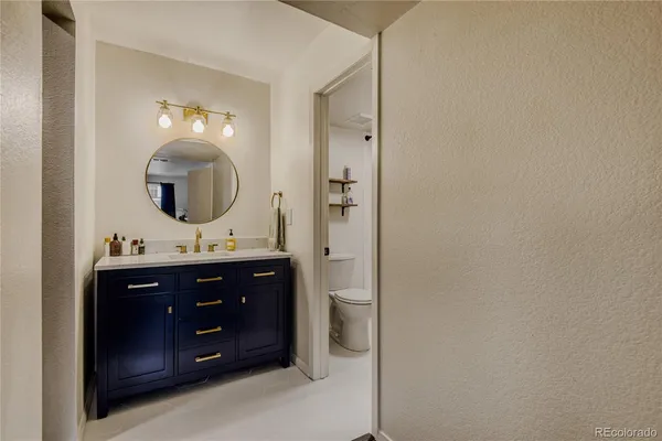 a bathroom with a sink vanity and mirror
