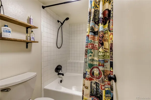 a bathroom with a shower and a toilet