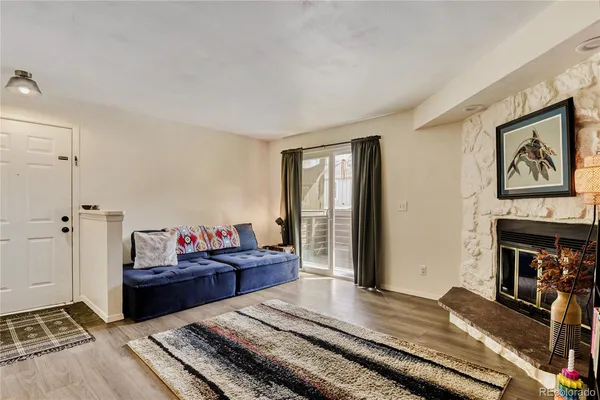 a living room with fireplace furniture and a window