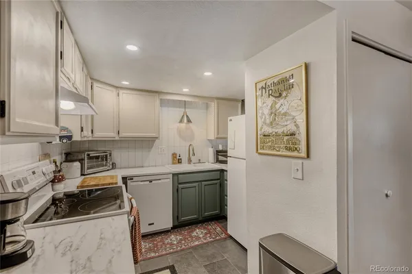 a kitchen with a sink a stove and cabinets
