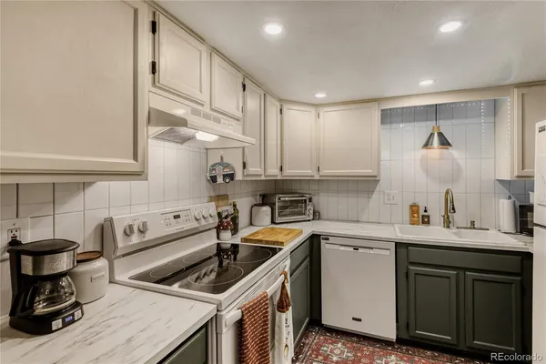 a kitchen that has a sink and a stove in it