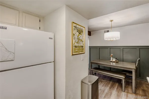 a kitchen with a refrigerator and a table
