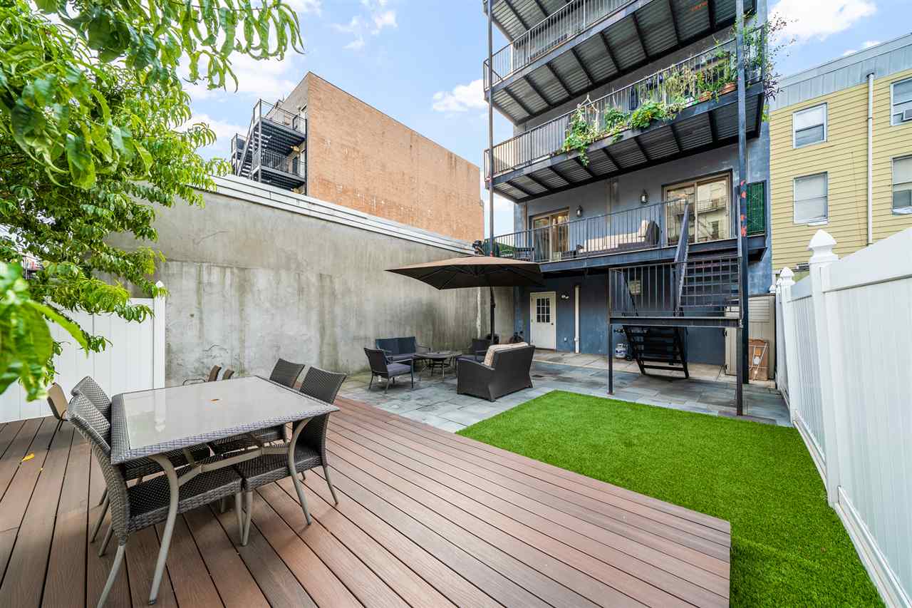 a view of backyard with a patio and outdoor seating