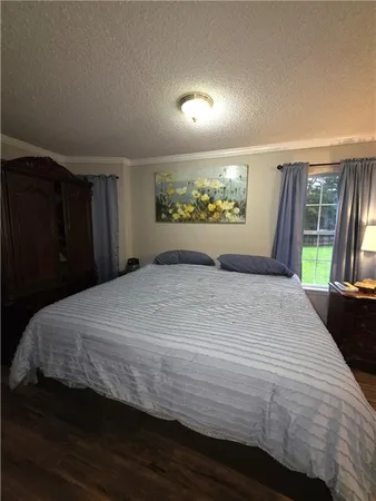 a bedroom with a bed and a large window