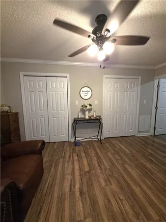 a living room with a bed furniture and a window
