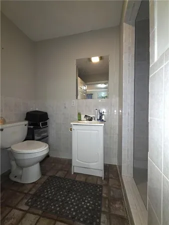 a bathroom with a toilet and a shower