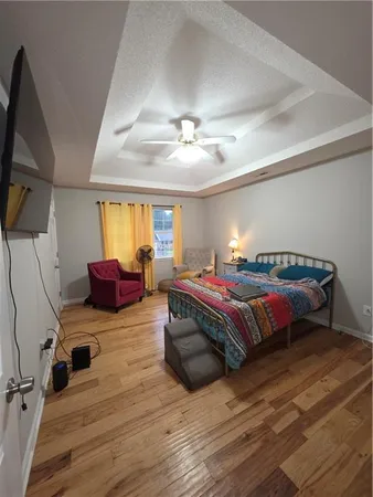 a spacious bedroom with a bed and window