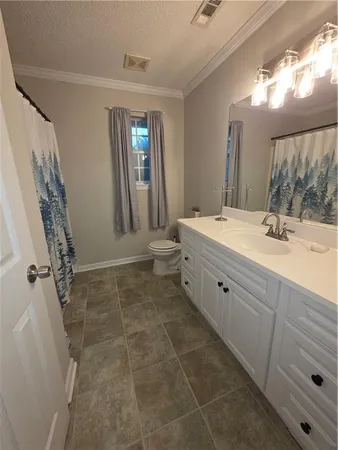a bathroom with a sink vanity and mirror