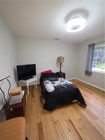 a bedroom with a bed and a television