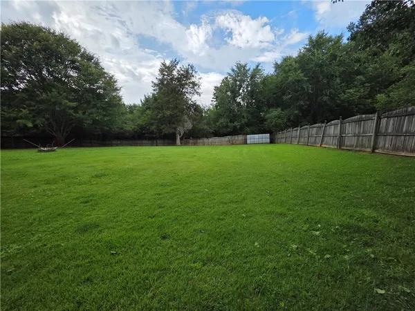 a view of a grassy field with trees