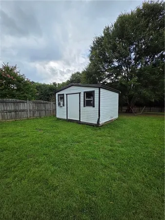 a view of a house with backyard and garden