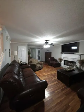 a living room with furniture a fireplace and a flat screen tv