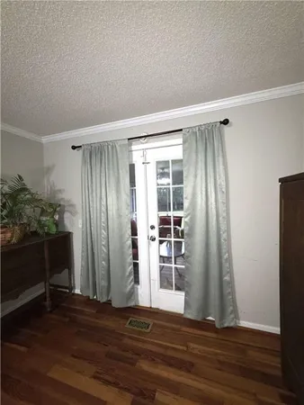 a view of wooden floor and windows in a room
