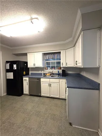 a kitchen with stainless steel appliances granite countertop a refrigerator and sink
