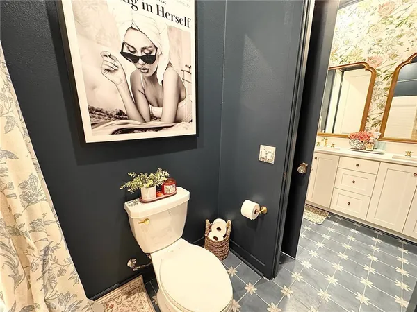 a bathroom with a toilet a sink and mirror