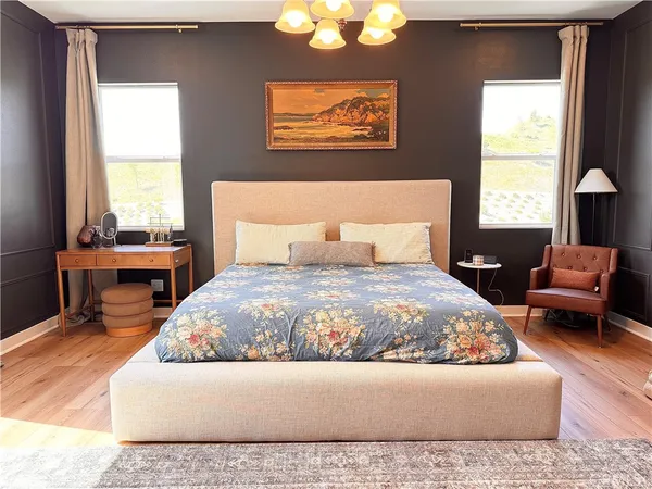 a living room with a bed furniture and a large window