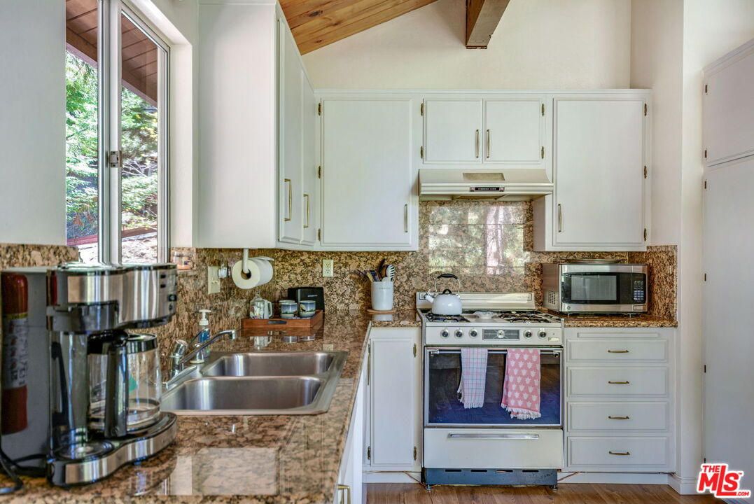 2378 Rim Of The World Drive Running Springs, CA 92382 - Photo 12 of 33 a kitchen with stainless steel appliances granite countertop a stove and a sink