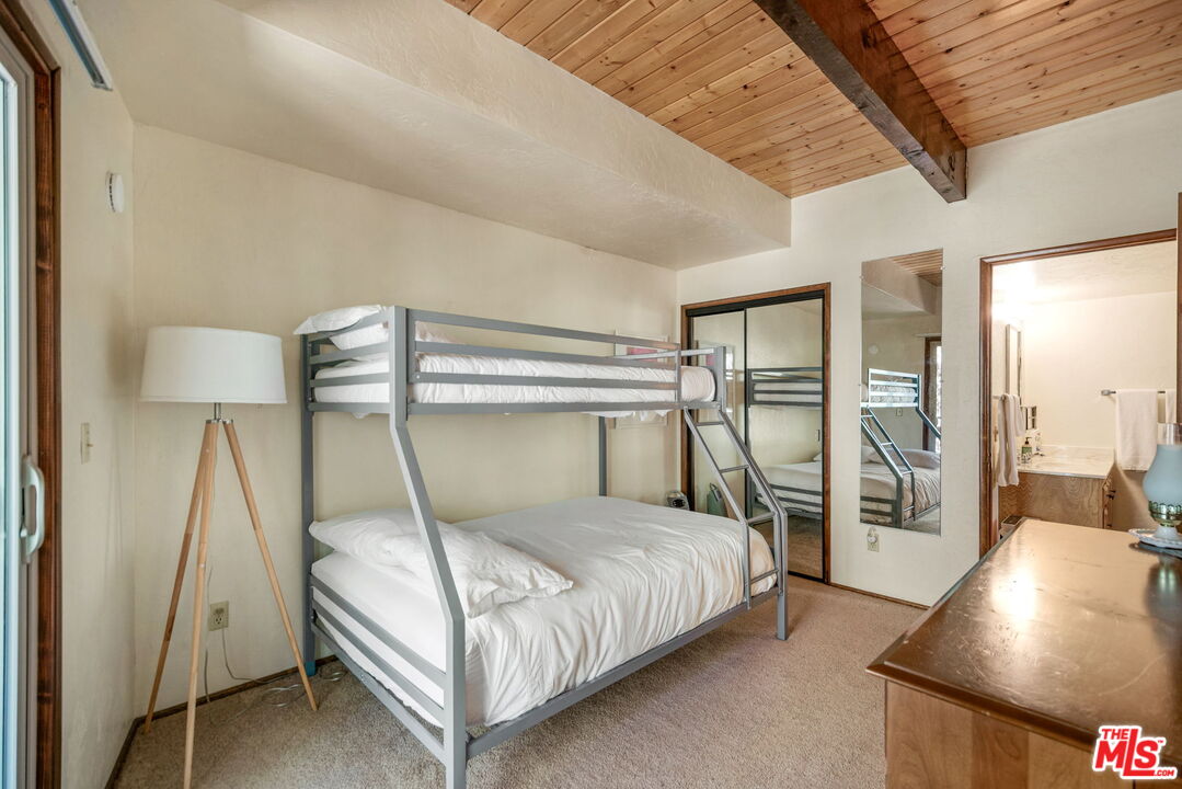 2378 Rim Of The World Drive Running Springs, CA 92382 - Photo 15 of 33 a bedroom with a bed and glass walk in closet
