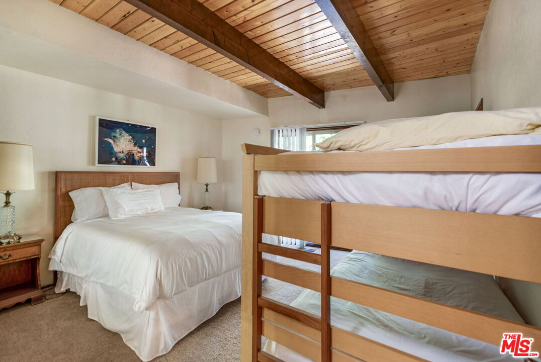 2378 Rim Of The World Drive Running Springs, CA 92382 - Photo 19 of 33 a bedroom with a bed and a window