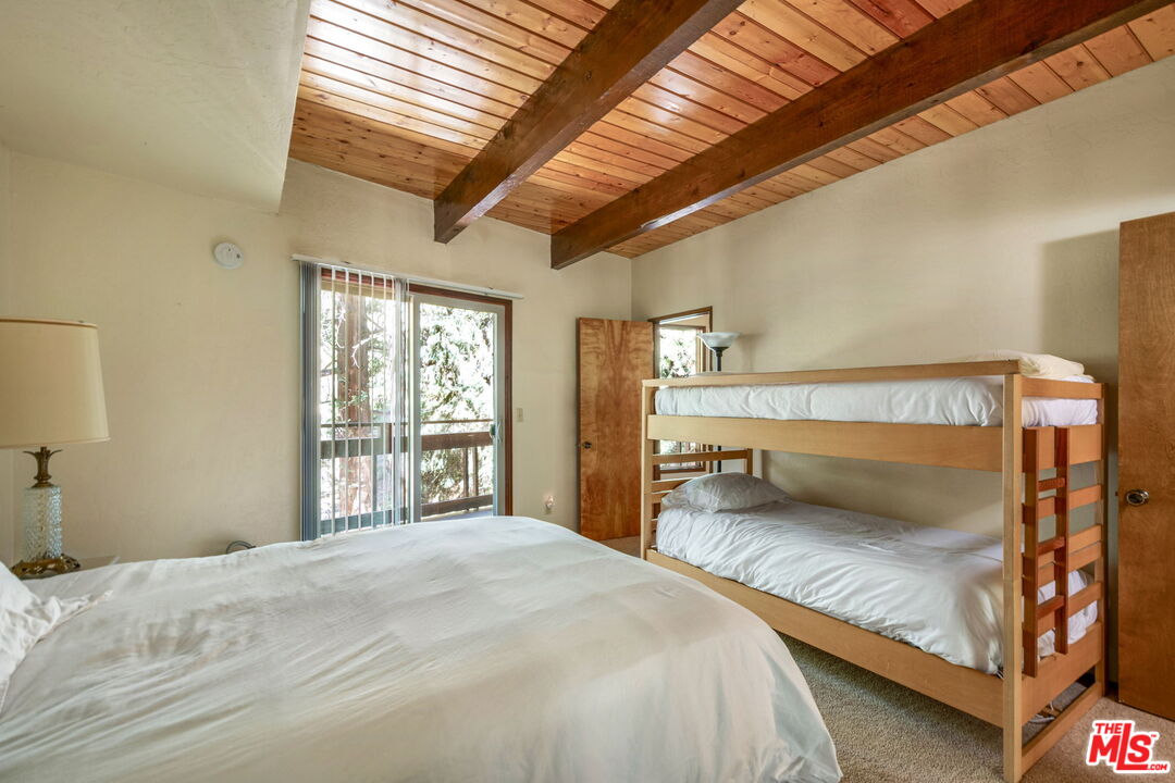 2378 Rim Of The World Drive Running Springs, CA 92382 - Photo 20 of 33 a bedroom with a bed and a large window