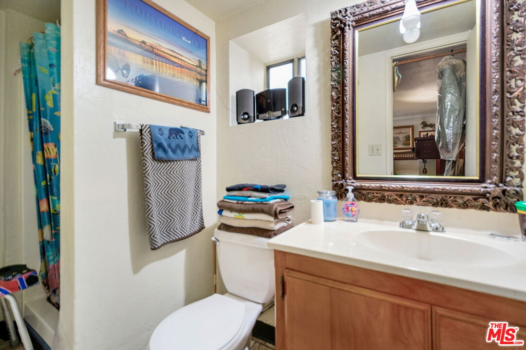 2378 Rim Of The World Drive Running Springs, CA 92382 - Photo 24 of 33 a bathroom with a sink mirror toilet and vanity