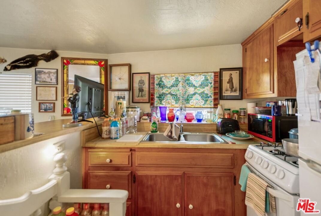 2378 Rim Of The World Drive Running Springs, CA 92382 - Photo 25 of 33 a view of a kitchen with a sink and a refrigerator