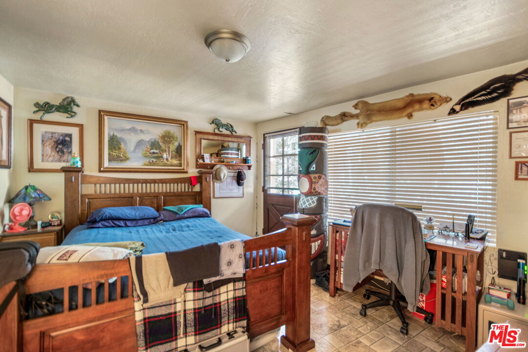 2378 Rim Of The World Drive Running Springs, CA 92382 - Photo 26 of 33 a bedroom with furniture and a window