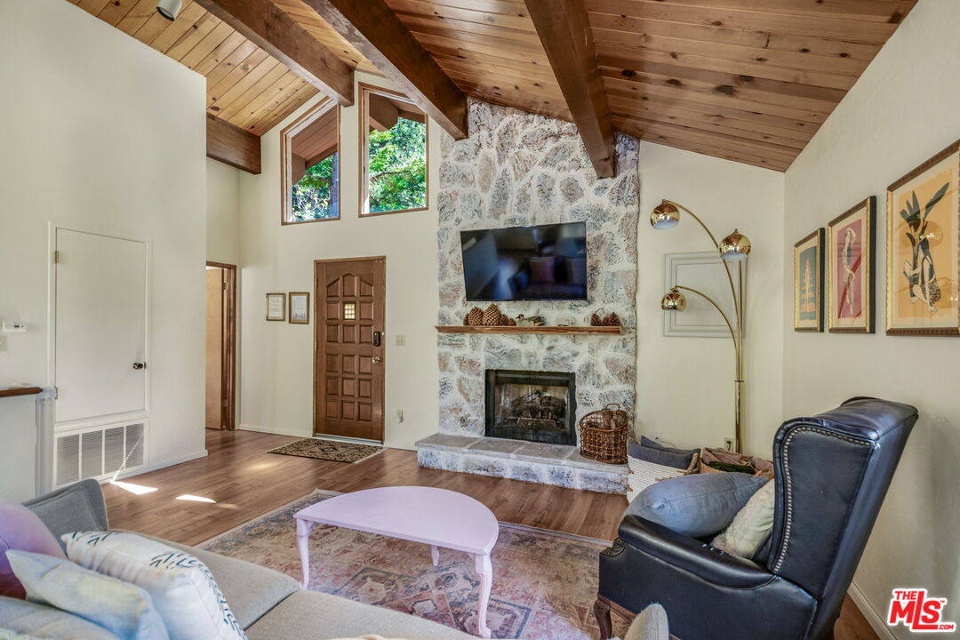 2378 Rim Of The World Drive Running Springs, CA 92382 - Photo 5 of 33 a living room with furniture a flat screen tv and a fireplace