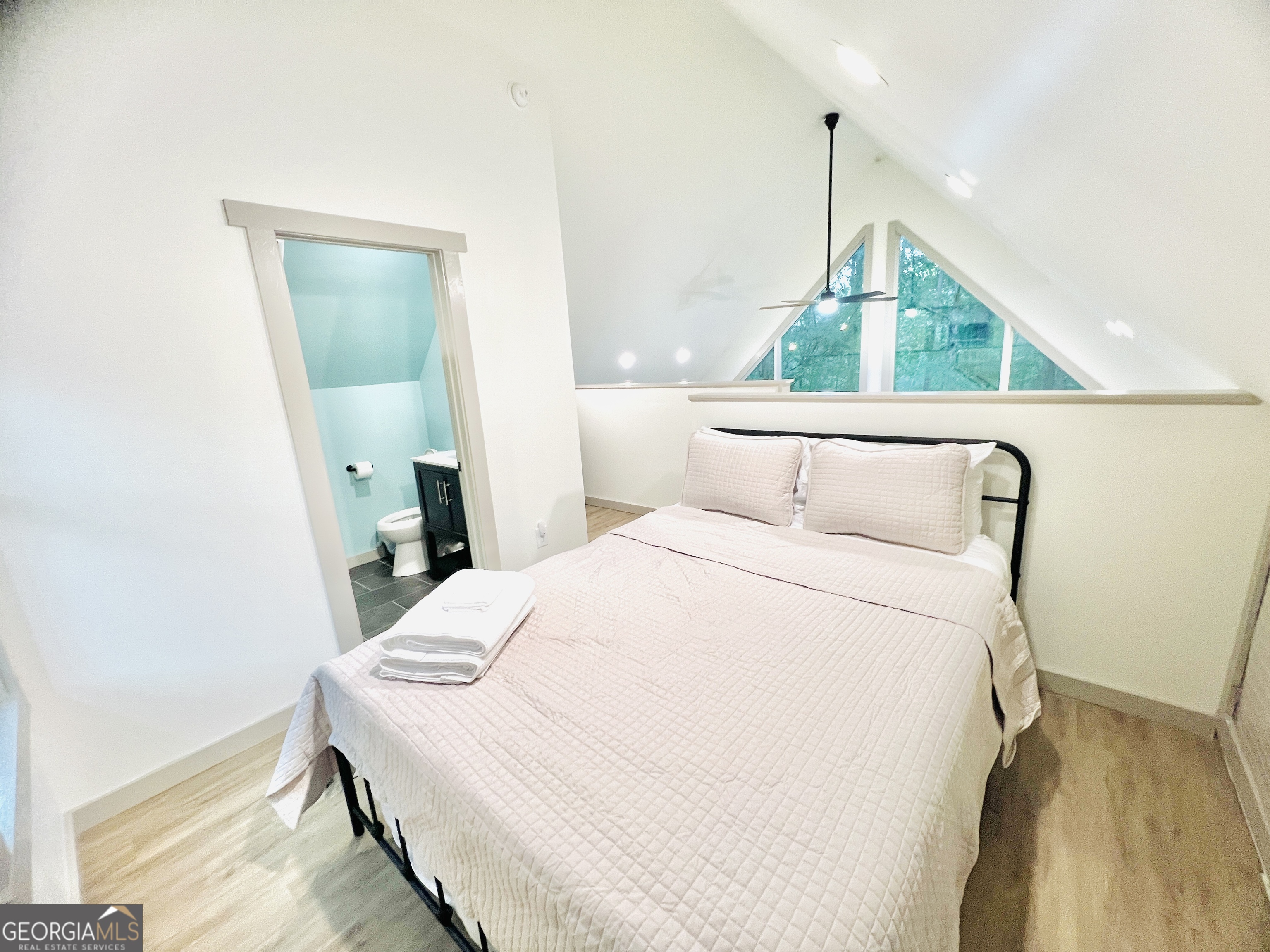 788 Lakeshore Road Martin, GA 30557 - Photo 20 of 29 a bedroom with a bed a mirror and a window