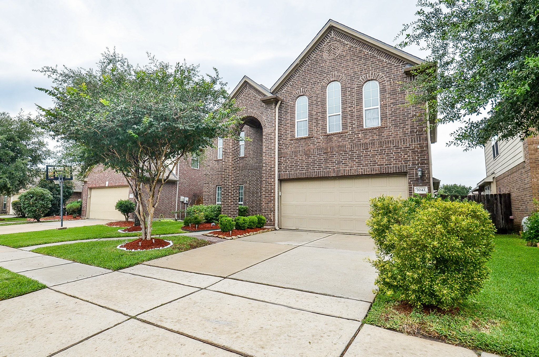 7042 Sliding Rock Circle Spring, TX 77379 - Photo 1 of 36 Stunning curb appeal with elegant brick facade and lush landscaping.