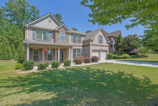 a front view of a house with a yard